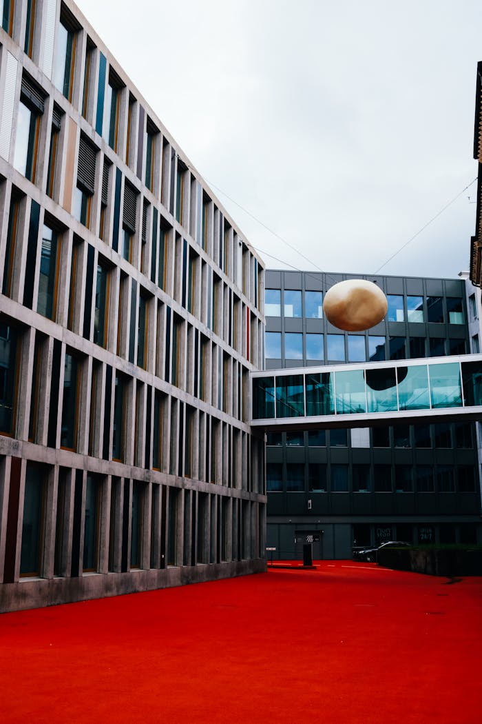 Modern buildings with unique art installation in Swiss urban setting.